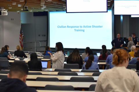 Civilian training showing an auditorium and big screes